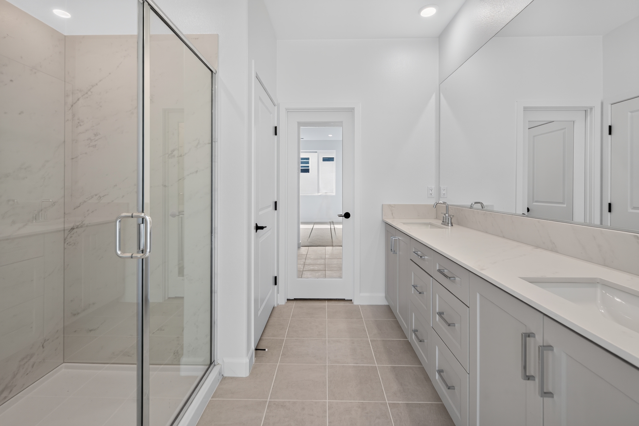 Walk-in glass shower with marble-look tile and double vanity — tub-to-shower conversion example in South Jersey