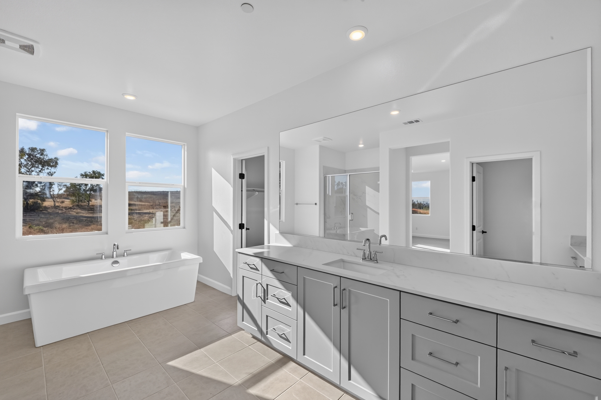 Full gut remodel — freestanding soaking tub, double vanity with quartz countertop, large-format tile, New Jersey
