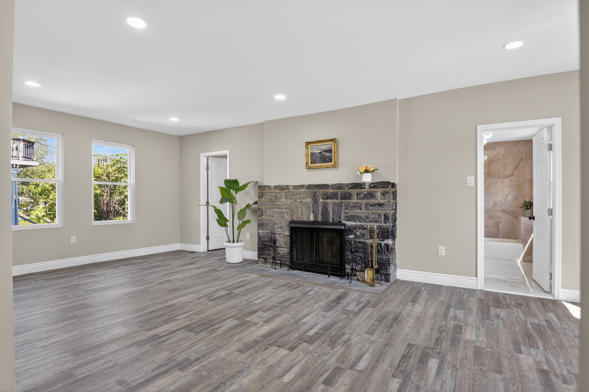 A freshly renovated living room with new flooring and fireplace
